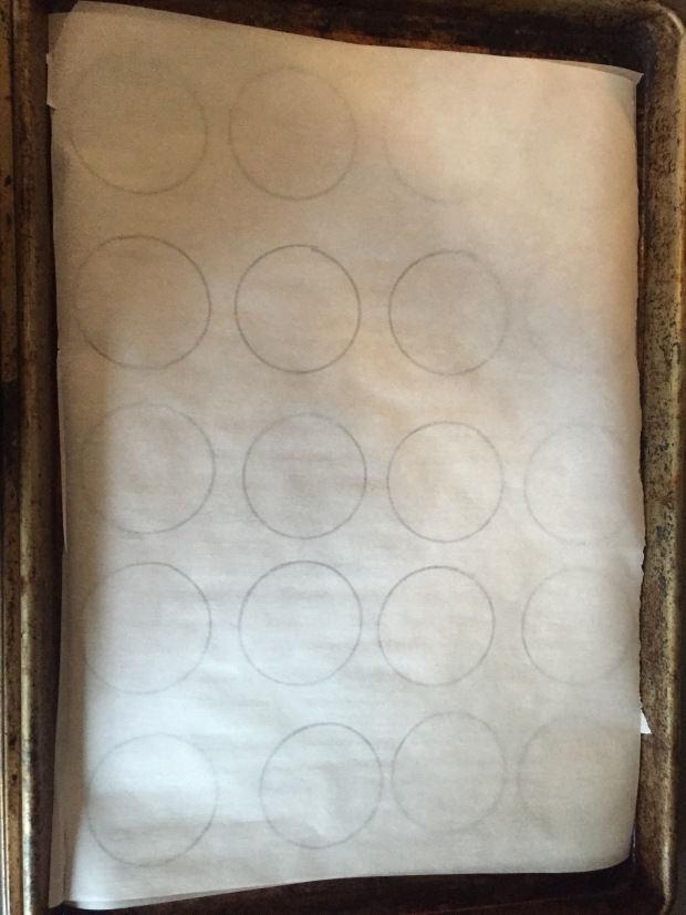 trace circles on parchment that can be slid out from under the macarons parchment