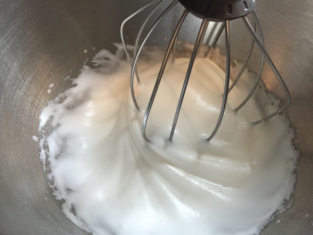 beat egg whites until soft peaks form, adding 35g of sugar at this point